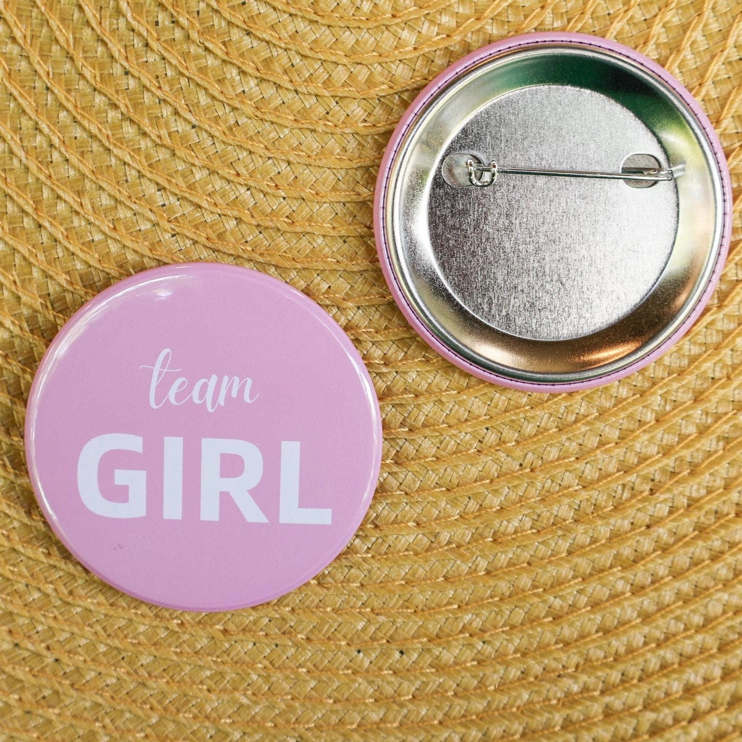 Close up team girl pin. Baby pink pin front and back. perfect baby shower favor and fun game