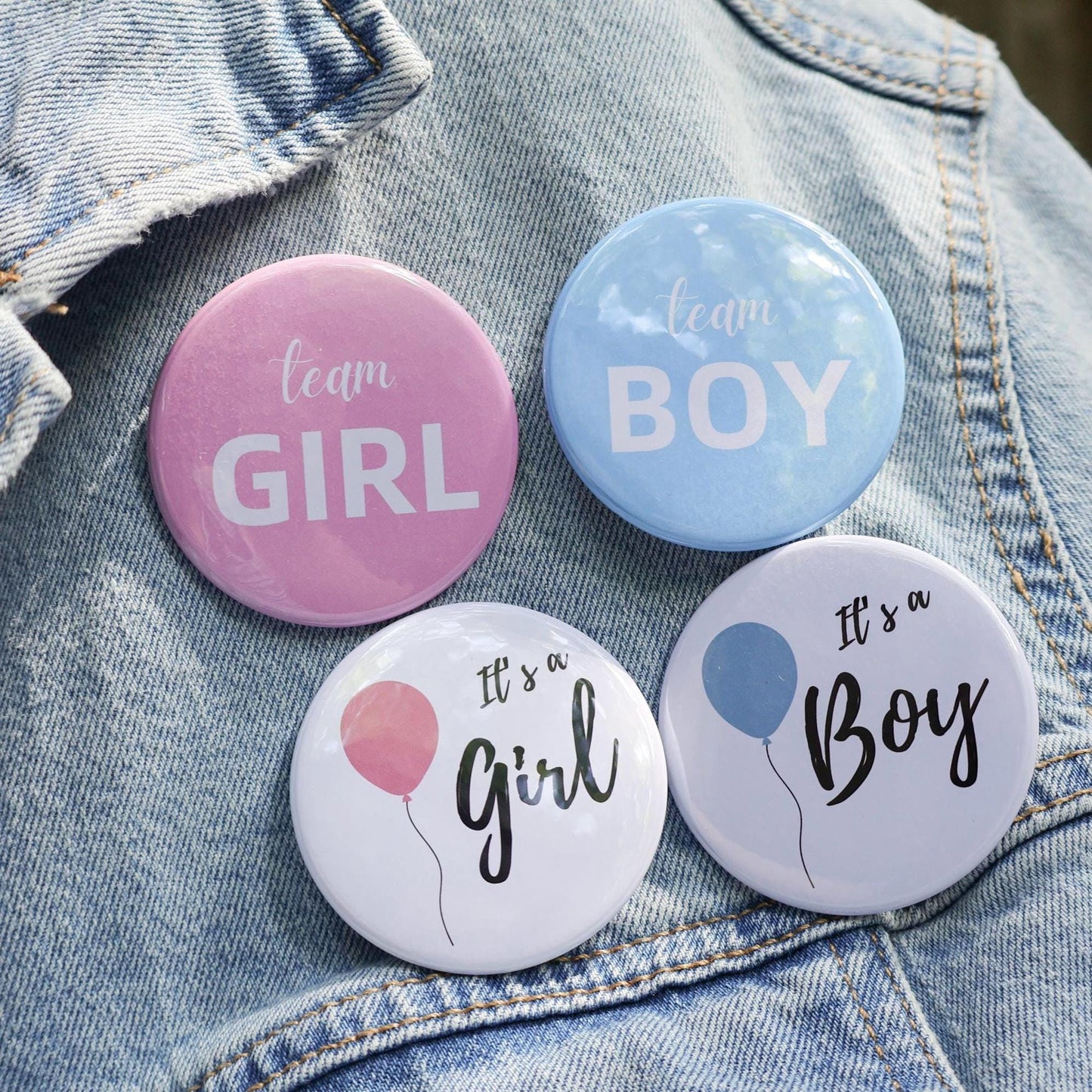 Gender reveal pins on denim jacket