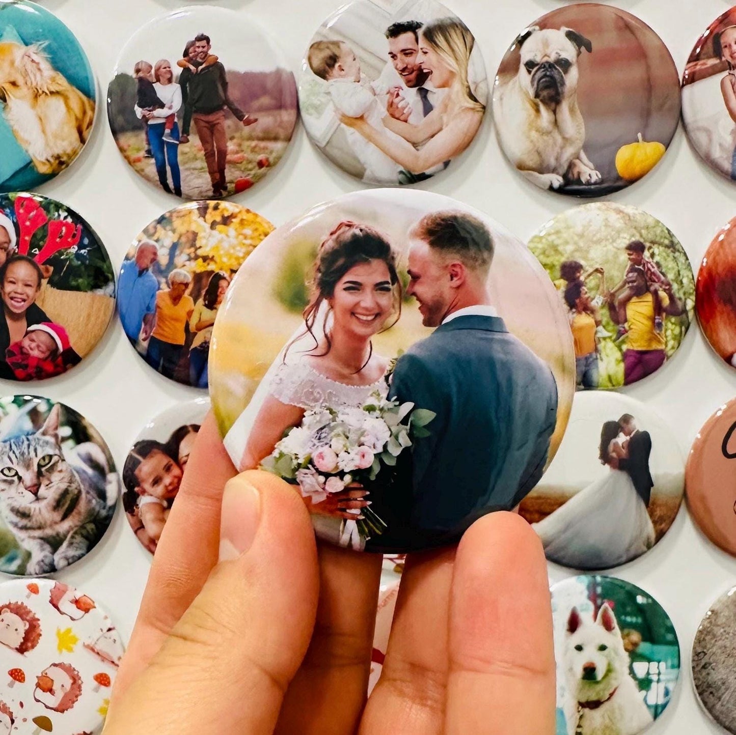 Collection of round photo magnets with various images, held by a hand. Wedding favor, Baby shower keepsake, birthday gifts