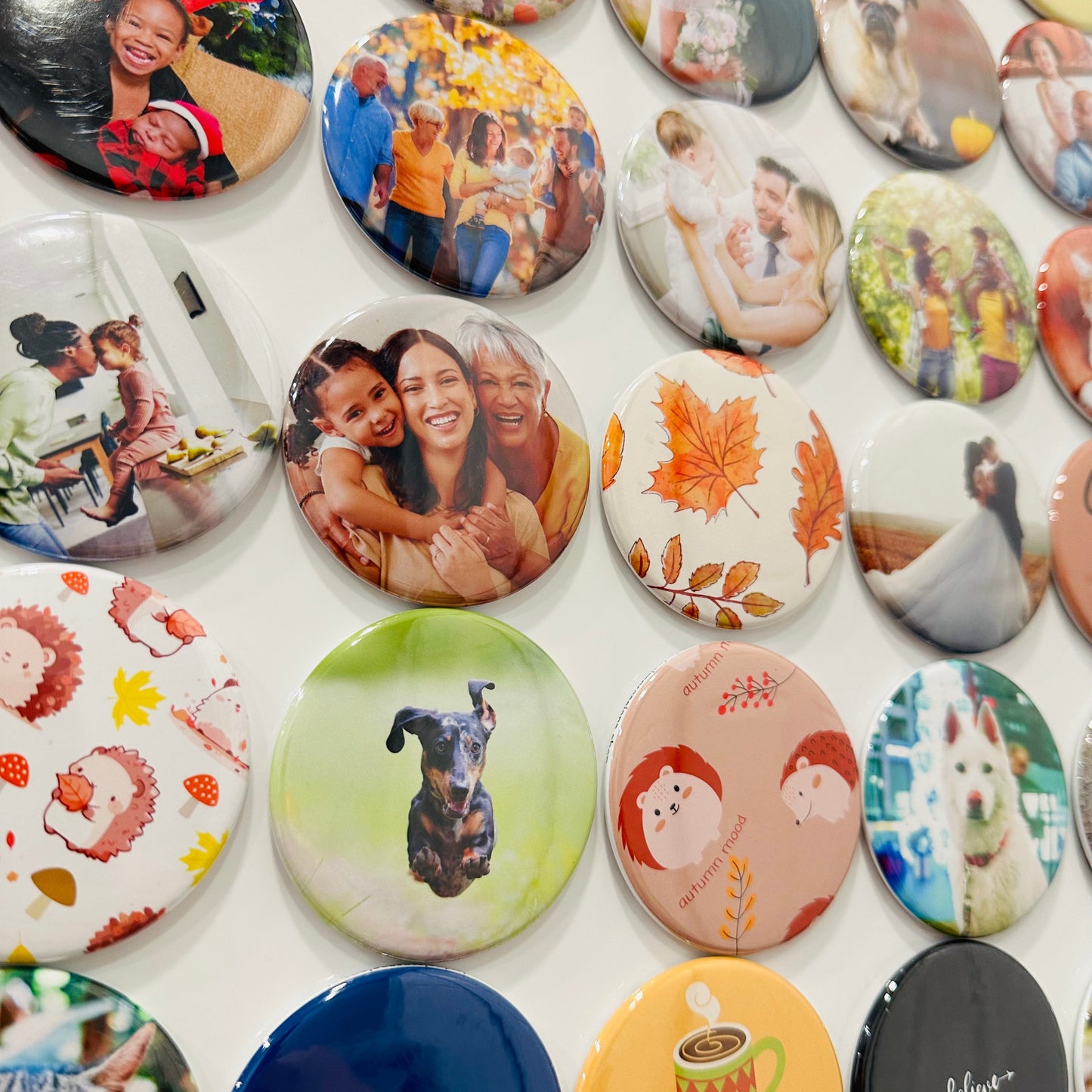 Collection of custom photo magnets with different designs on a white background