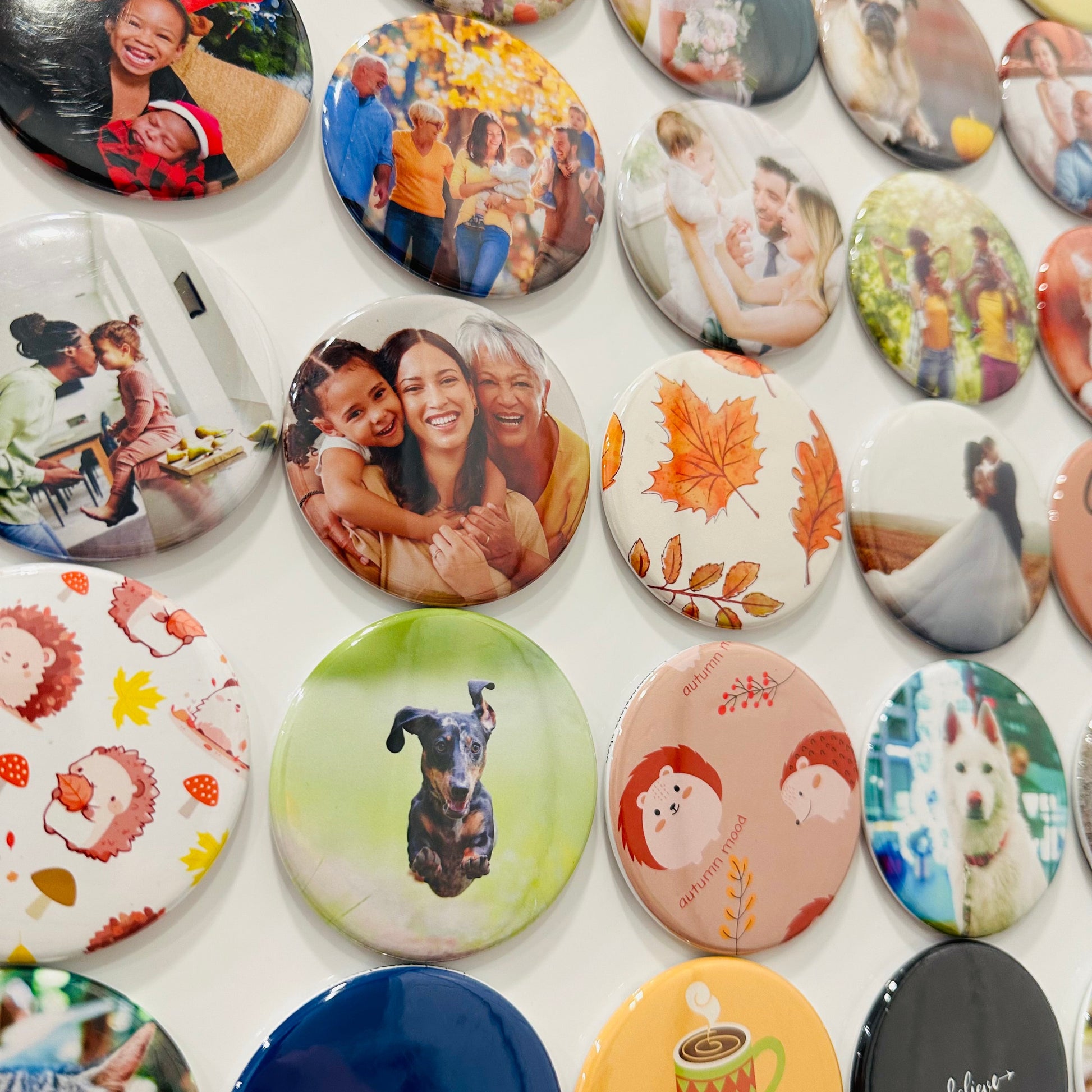 Collection of custom photo magnets with different designs on a white background