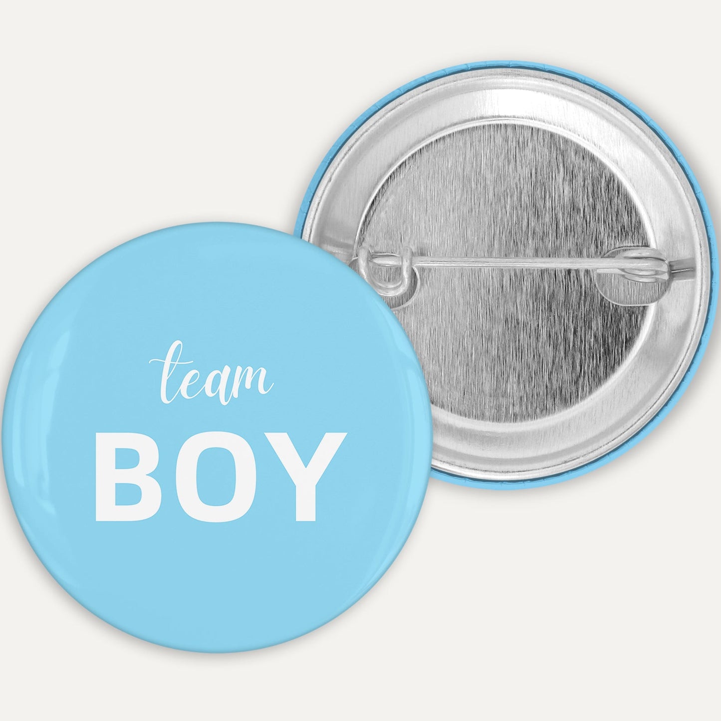Button badge with 'team BOY' text on a light blue background