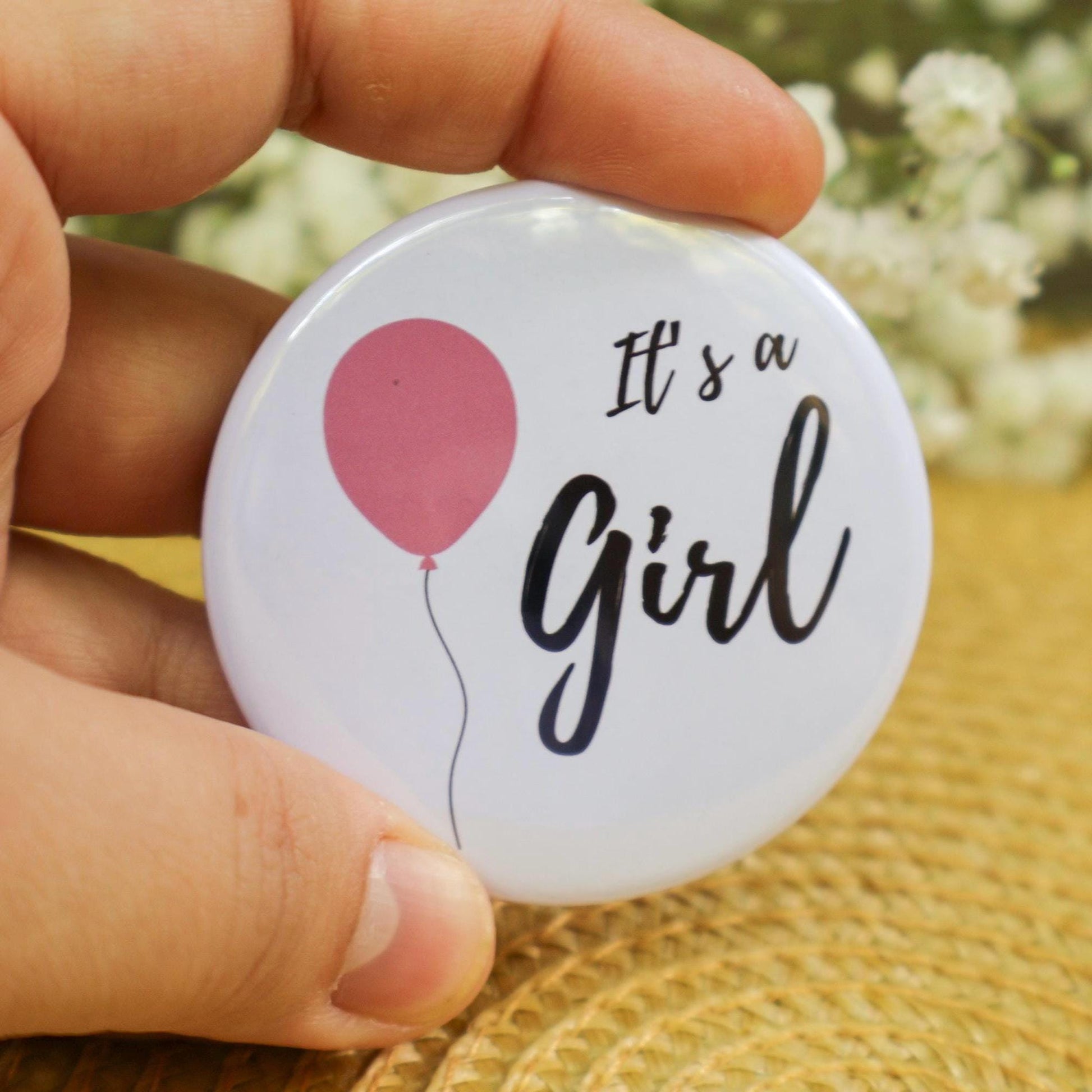 It's a girl pin with baby pink balloon. Baby shower game and gift