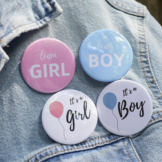 Four buttons labeled 'team GIRL', 'team BOY', 'It's a Girl', and 'It's a Boy' on a denim background.